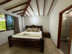 a bedroom with a large bed in a room at Hotel Santorini Doradal in Doradal