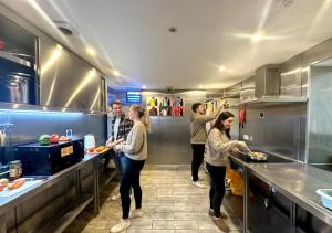 a group of people in a kitchen preparing food at Smart Hyde Park Inn in London