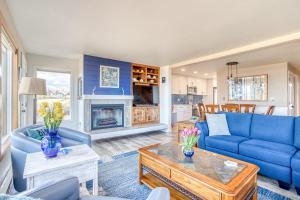 a living room with blue furniture and a fireplace at Breakers Beach House 9 - Meredith Lodging in Neskowin