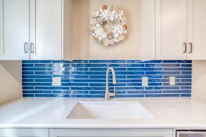 a kitchen with a sink and a wreath on the wall at Breakers Beach House 9 - Meredith Lodging in Neskowin +60 photos