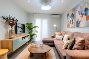 a living room with a couch and a table at UNIQUE HOMES LAS SETAS LA CAMPANA in Seville