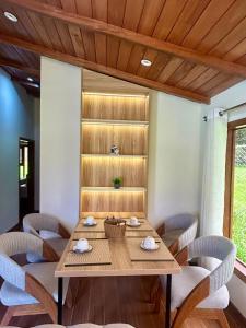 a dining room with a wooden table and chairs at Casa del abuelo Lodge in Cajamarca +5 photos