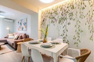 a living room with a white table and chairs at UNIQUE HOMES LAS SETAS LA CAMPANA in Seville