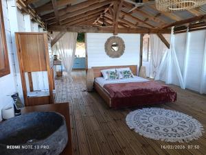 a bedroom with a bed and a tub in a room at Tootila in Sainte-Rose
