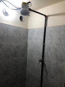 a bathroom with a shower with a light on the ceiling at Hospedaje las Primicias 103 in Riobamba