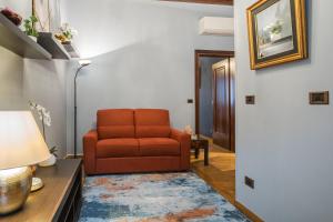 a living room with a red chair and a table at Ca' del Pope in Venice +55 photos