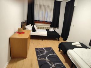 a small room with two beds and a window at Haus - Baden-Baden - 8x Zimmer in Sandweier