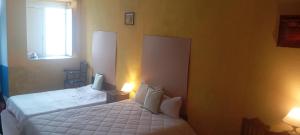 a bedroom with two white beds and a window at ViSIT CASTELO BRANCO in Castelo Branco
