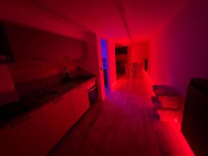 a kitchen with red and blue lights in a room at Mini Suite Apartment 2 in Castel di Sangro +10 photos