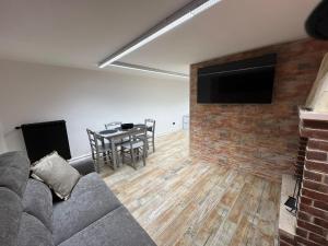 a living room with a couch and a table and a television at Mini Suite Apartment 2 in Castel di Sangro