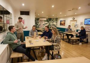 a group of people sitting at tables in a restaurant at Smart Hyde Park View in London