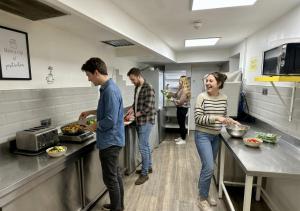 a group of people in a kitchen preparing food at Smart Hyde Park View in London