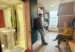 a man and a woman standing in a bathroom at Smart Hyde Park View in London
