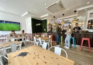 a group of people standing in a restaurant with tables at Smart Hyde Park View in London