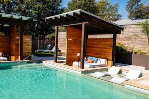 a swimming pool with a gazebo next to a swimming pool at Lucky Arrow Retreat in Dripping Springs