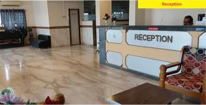 a lobby with a reception sign and a reception desk at Hotel Shiv Sai in Shirdi