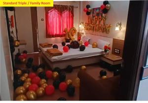 a bedroom with balloons and a bed with a bed sqor at Hotel Shiv Sai in Shirdi