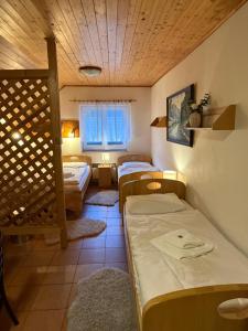 a room with three beds and a window at Bouda Malenovice in Malenovice