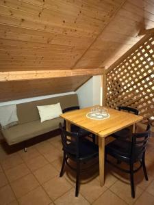 a table and chairs in a room with a couch at Bouda Malenovice in Malenovice +19 photos