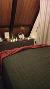 a bedroom with a bed and a dresser with a bed sqor at Cabana Quintal in Aquidauana
