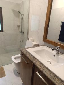 a bathroom with a sink and a toilet and a shower at Golden Leaf house in Weligama +25 photos