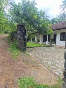 a stone pillar in front of a house at Golden Leaf house in Weligama