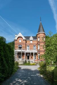 a large brick building with a tower on top at Villa Grand Maur in Spa