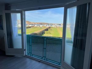 a balcony with a view of a golf course at Bon Diaz at Sea in Julianadorp