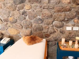 a bench with a brush on it in front of a stone wall at Tariq Boutique in Cusco
