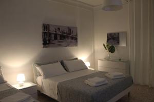 a bedroom with a bed with two lamps on it at Felicia in Bisceglie
