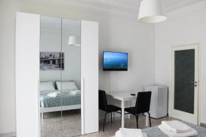 a bedroom with a bed and a table and chairs at Felicia in Bisceglie