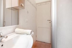 a white bathroom with a sink and a toilet at Residenza Torre Antica - Nel Cuore di Viterbo in Viterbo