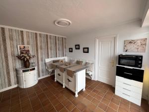 a kitchen with a table and chairs in a room at Torkes in Foz +9 photos
