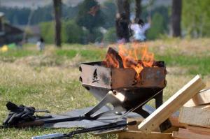 a grill with a fire in a field at Fes nature in Fez