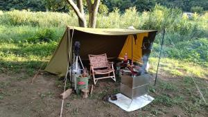 a tent with a chair next to a stove at Fes nature in Fez