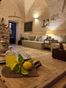 a table with lemons and a bottle of lemon juice at Masseria Morrone in Ostuni