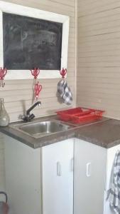 a kitchen counter with a sink and a window at Ons Strandhuisie N5 in Pearly Beach in Pearly Beach +18 photos