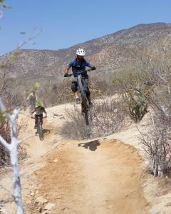 two people riding dirt bikes on a dirt trail at Amina Wind Resort by Tasman in Salinas