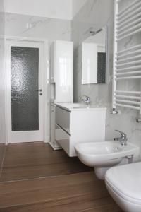 a white bathroom with a sink and a toilet at Felicia in Bisceglie +21 photos