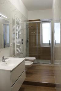a bathroom with a sink and a toilet and a shower at Felicia in Bisceglie