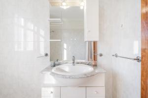 a white bathroom with a sink and a mirror at Vale do Vez in Arcos de Valdevez +51 photos