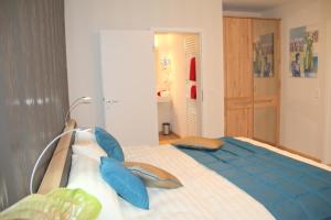 a bedroom with a large bed with blue pillows at BB Blick Hotel und Café in Bad Bellingen