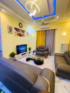 a large living room with couches and a tv at Résidence GOUDJA 2 in Cotonou +21 photos