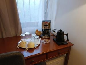a coffee maker on a table with affeepot and a coffee pot at Αγρόκτημα Agrikia Σπίτι in Arachova