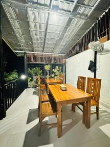 a dining room with a wooden table and chairs at Mama Homestay in Kuta Lombok