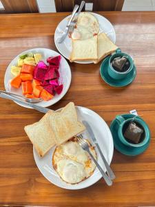 three plates of breakfast foods on a table at Mama Homestay in Kuta Lombok +9 photos