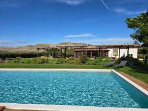 a swimming pool in front of a house at Agriturismo Essentia dimora rurale in Larino