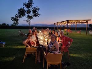 a group of people sitting at a long table at Agriturismo Essentia dimora rurale in Larino +181 photos