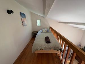 a bedroom with a bed with a wooden floor at le mas au pied du Ventoux in Carpentras +5 photos