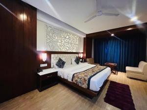 a bedroom with a large bed and a blue curtain at mayur Mora in Rāmgarh